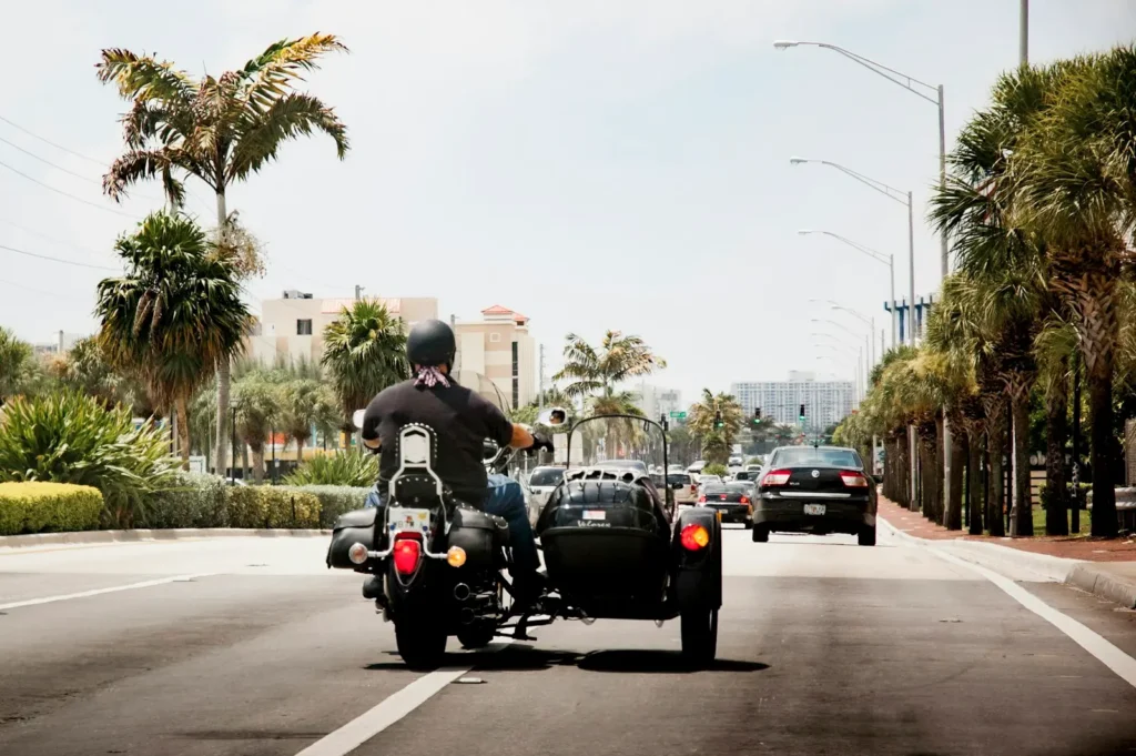 Motorcyclist riding on a palm-lined Miami street
