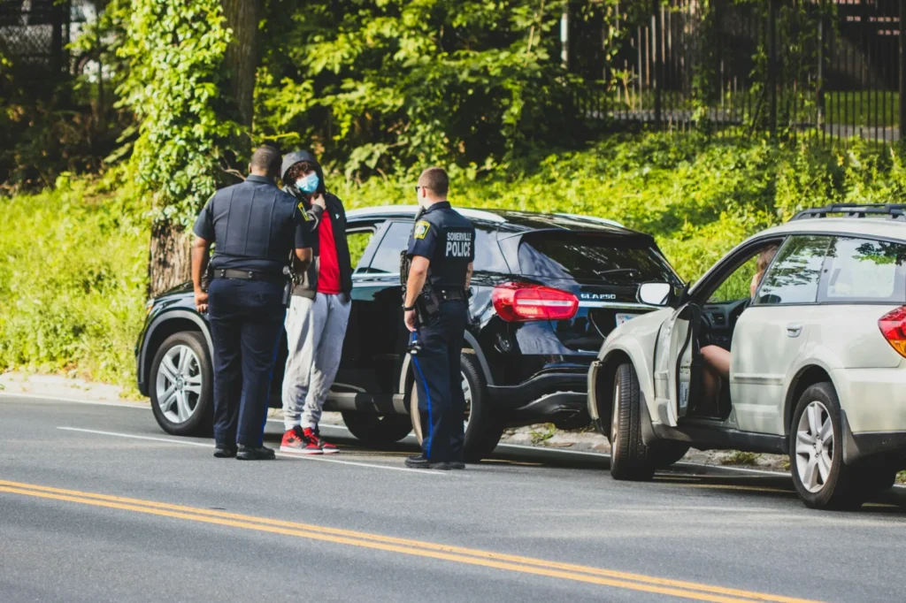 How to report a car accident in Florida: police officers speak with a driver at a crash scene